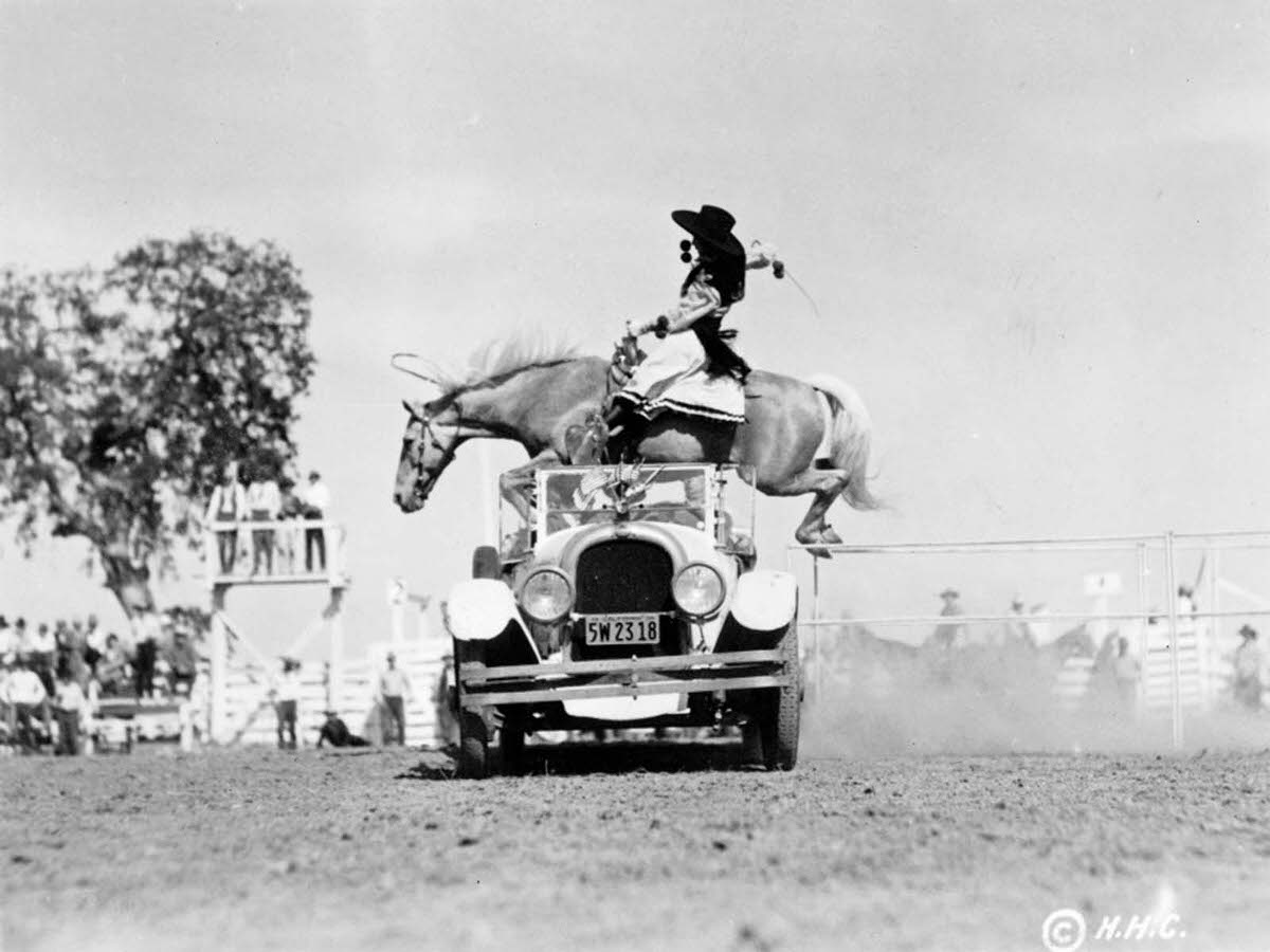 #3 A woman and her horse hurdle a convertible at a California rodeo. 1934.