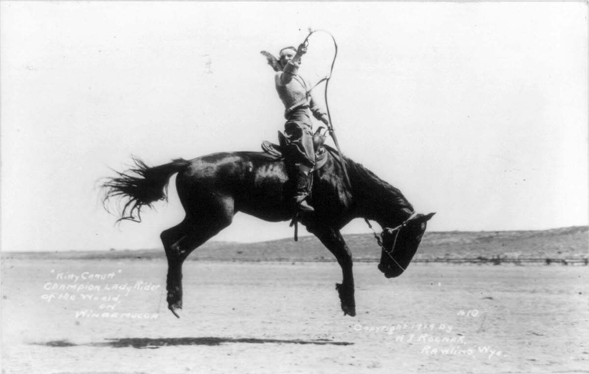 #12 Kitty Canutt, “champion lady rider of the world on Winnemucca,” on a bucking bronco, in 1919.