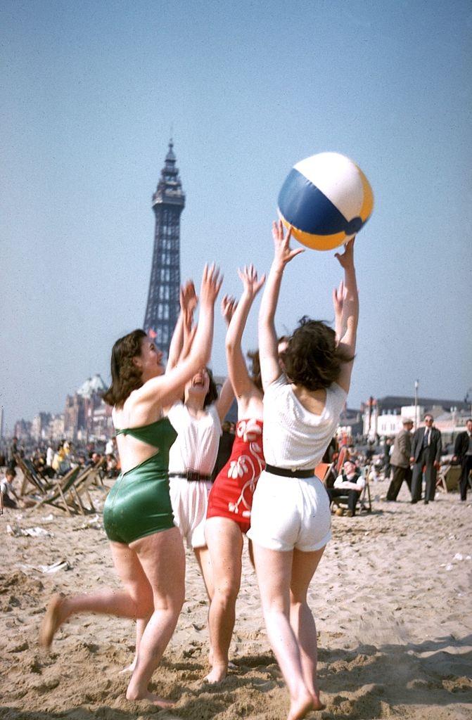 #7 A group of young women play with a beach ball on Blackpool beach, 1955.