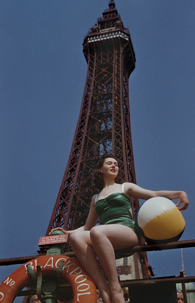 #8 A young woman with a beach ball in front of Blackpool Tower in Blackpool, Lancashire, UK, 23rd June 1955.