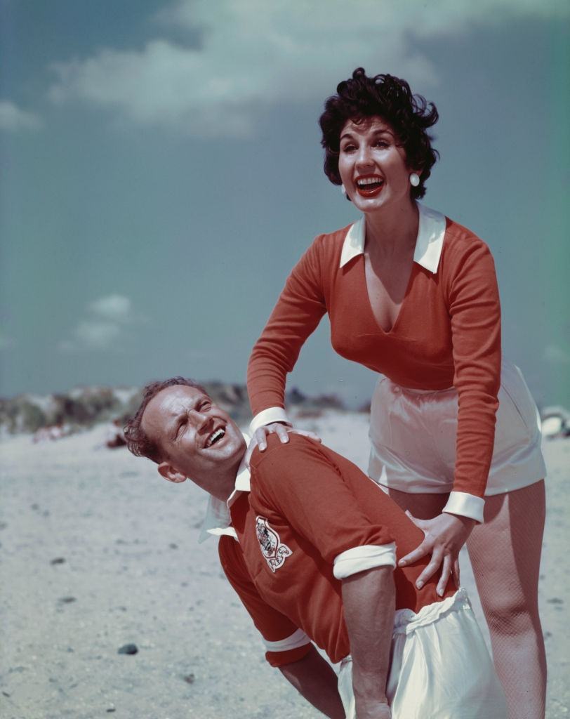 #10 English singer Alma Cogan with English footballer and captain of Blackpool FC, Harry Johnston on Blackpool, England in August 1955.