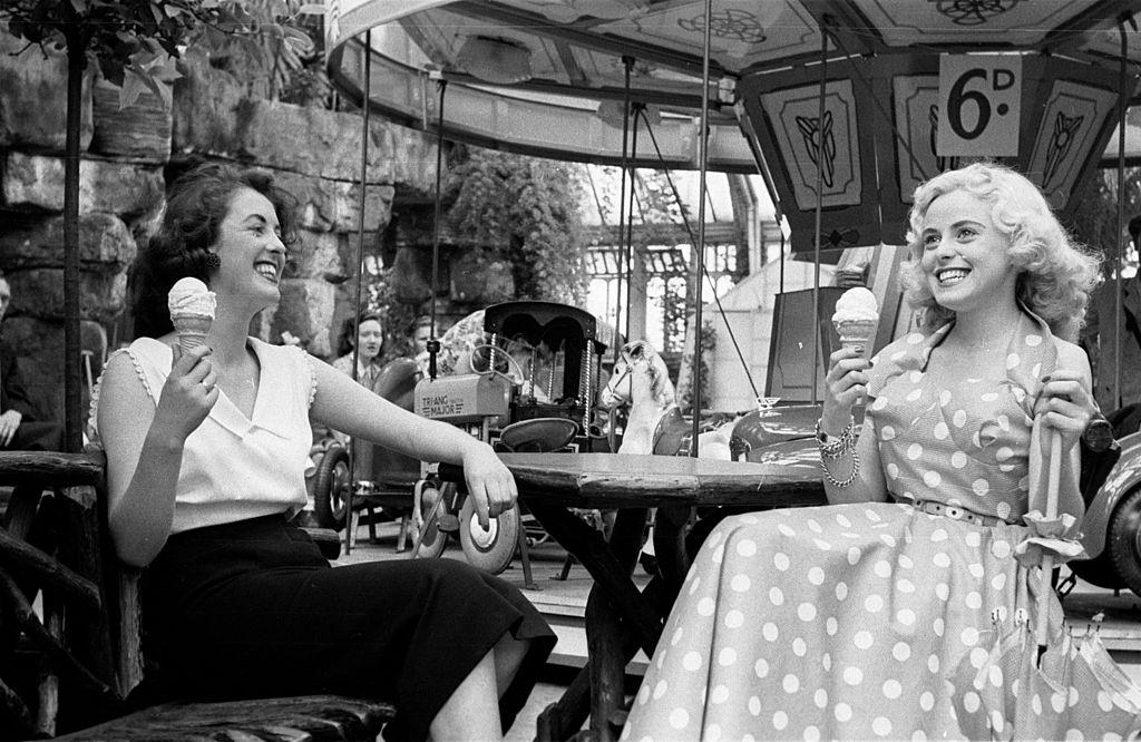 #24 Tourists enjoy icecreams at the fairground in the seaside resort of Blackpool, 1953.