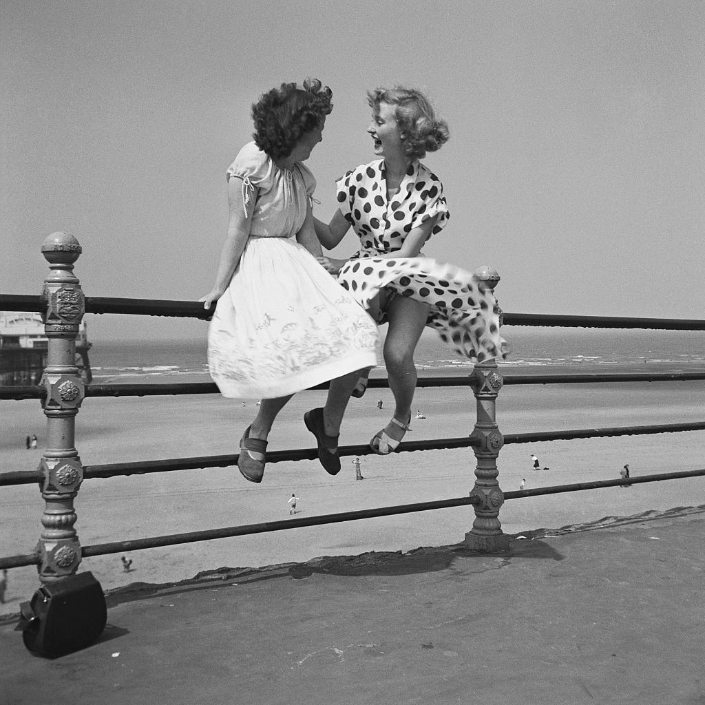 #35 wo women chatting on the railings in Blackpool, 1951.
