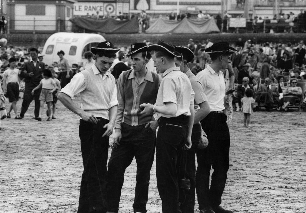 #52 A group of teenagers in cowboy hats on the beach at Blackpool, 1956.