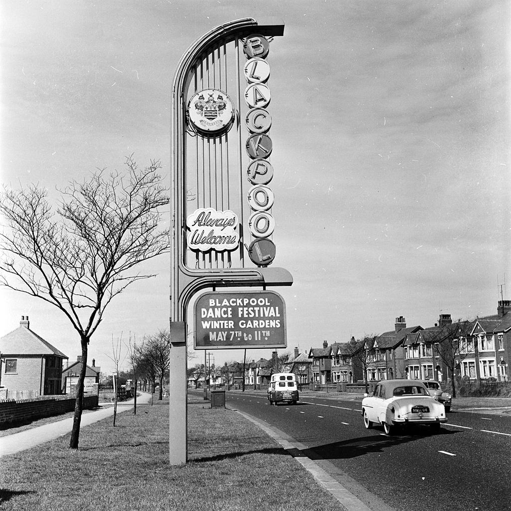 #57 A sign welcomes visitors to a dance festival in Blackpool seaside resort, 1956.