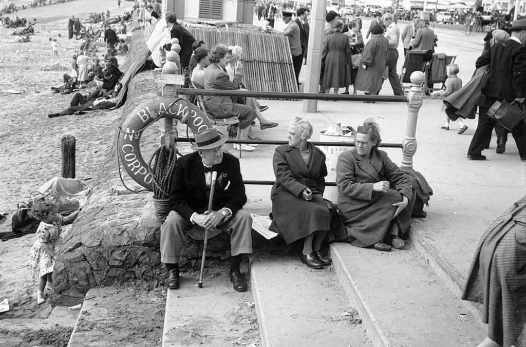 #59 Taking advantage of the spell of good weather, holiday makers enjoy themselves on the beach at Blackpool, 1956.