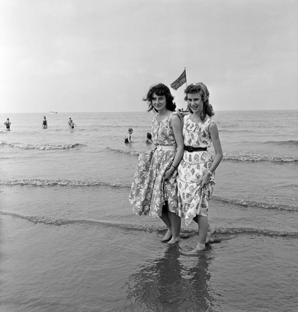 #63 Margaret Wright and Ethel Foster of Wigan paddling in the sea at Blackpool, 1957.
