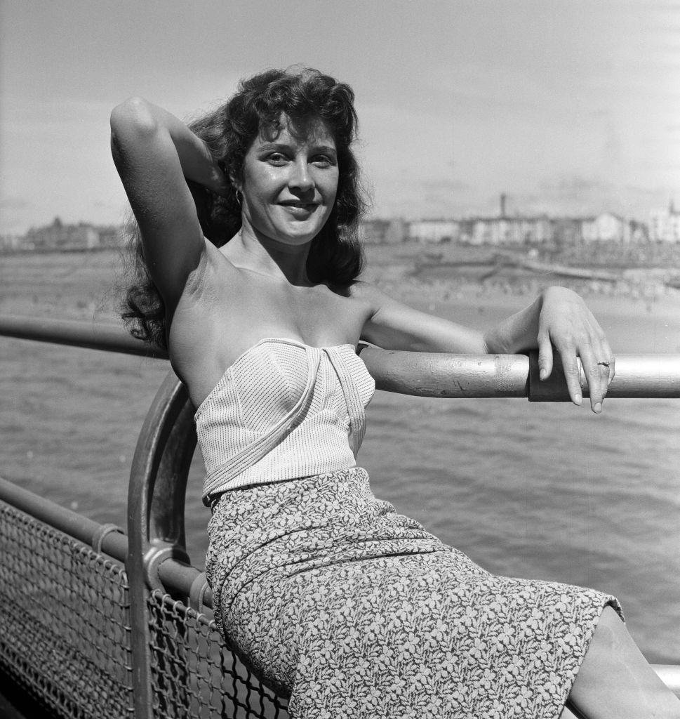 #66 A 22-year-old Veronica Cliff sitting on the rails at Blackpool, 1958