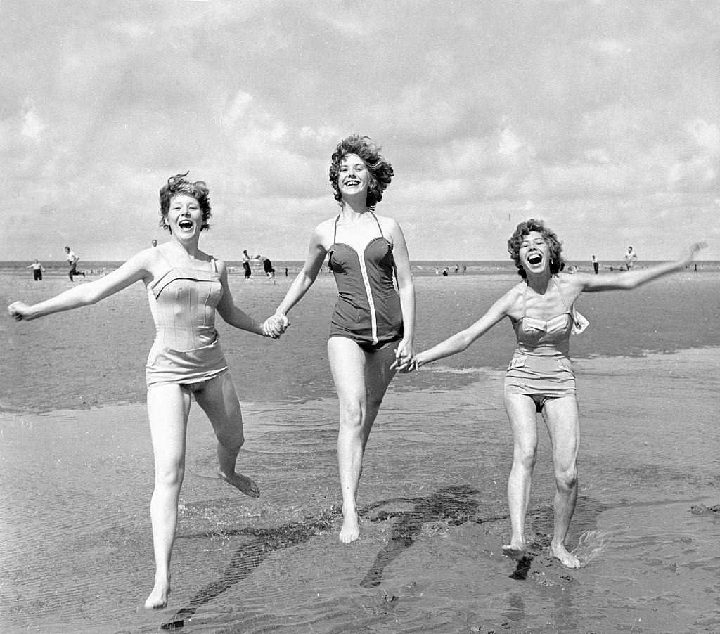 #67 Three girls holding hands on the beach at blackpool August 1958