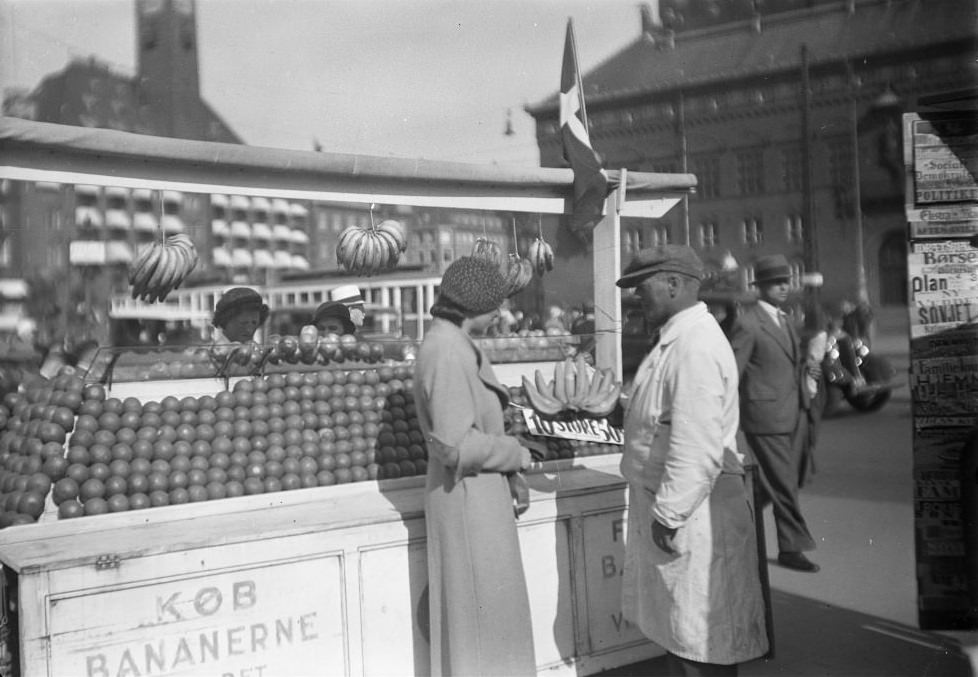 #30 Woman buys bananas at a fruit stand