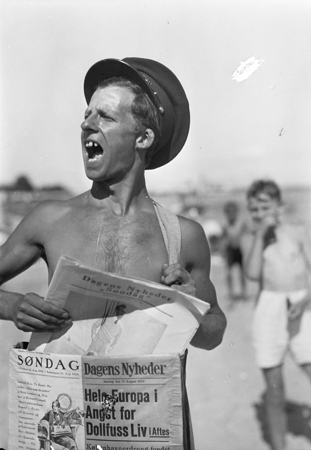 #130 Man selling newspapers