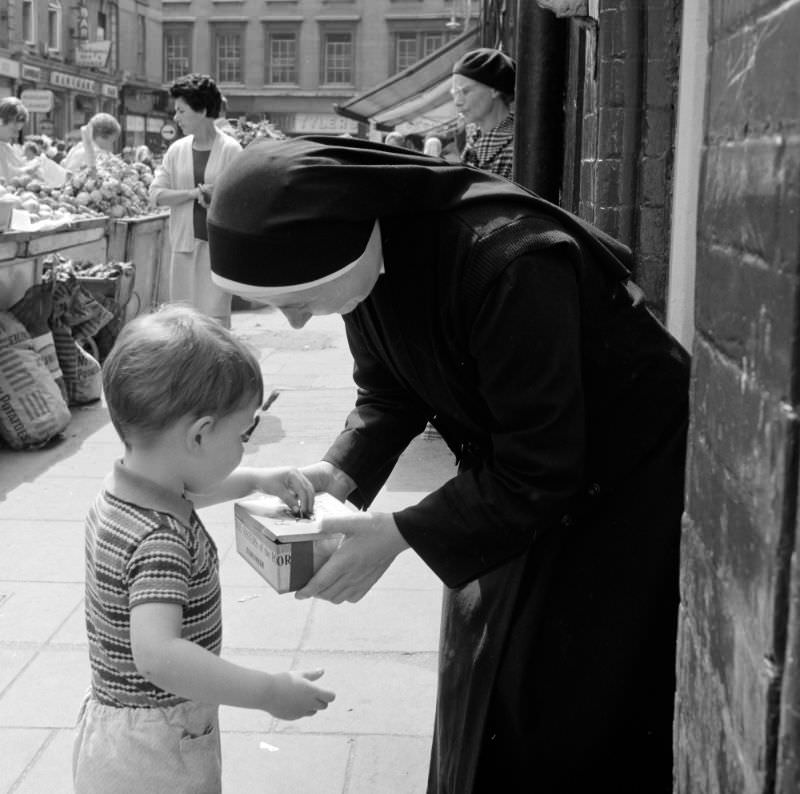 #26 Little boy putting money in nun’s collection tray, Dublin, 1969
