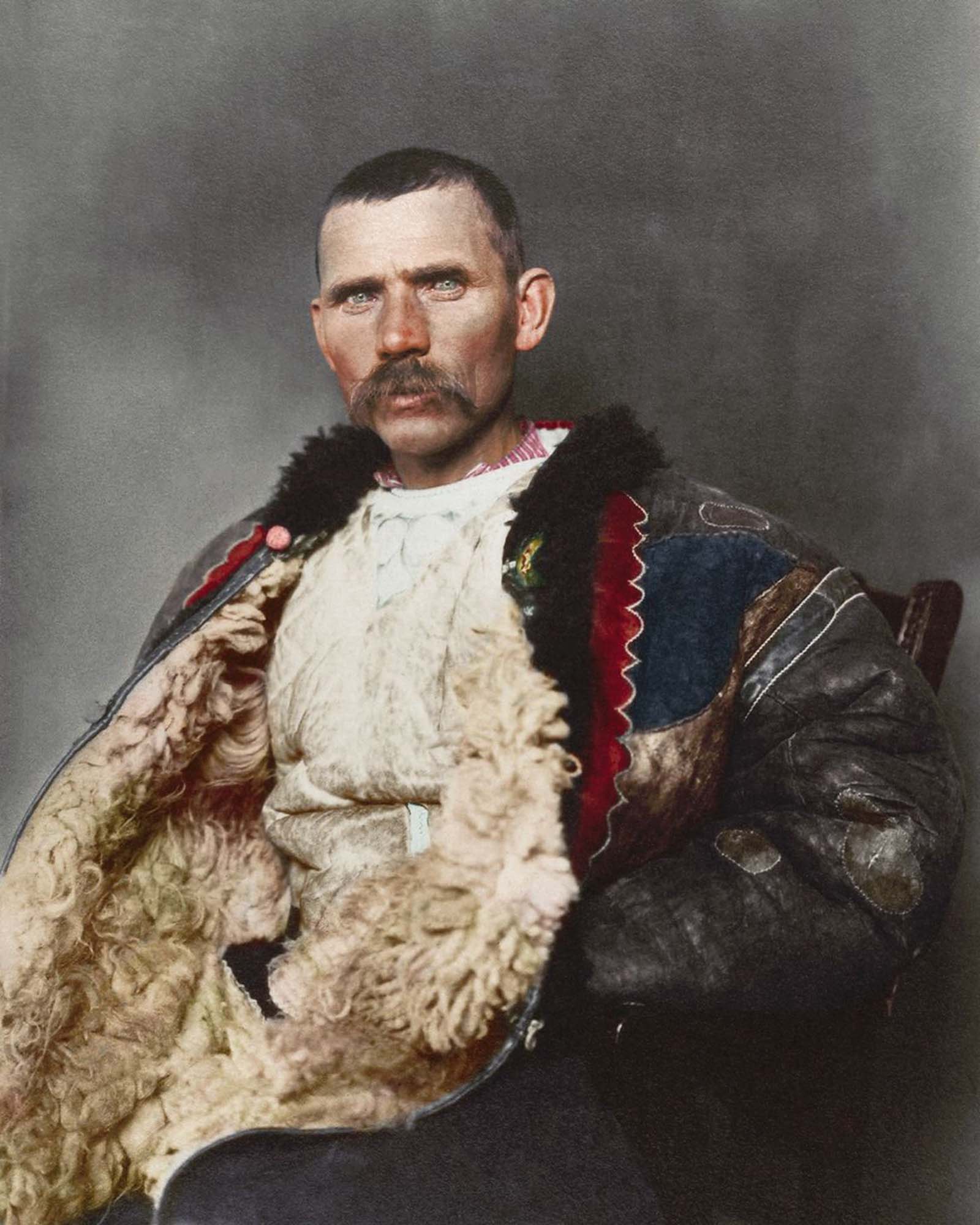 #13 Romanian shepherd.” Dominating the photograph is a traditional shepherd’s cloak known as sarică, made from three or four sheepskins sewn together with the fleece facing outwards and generally extended to below the knee, which could be used as a pillow when sleeping outdoors. Sheepskin was also used