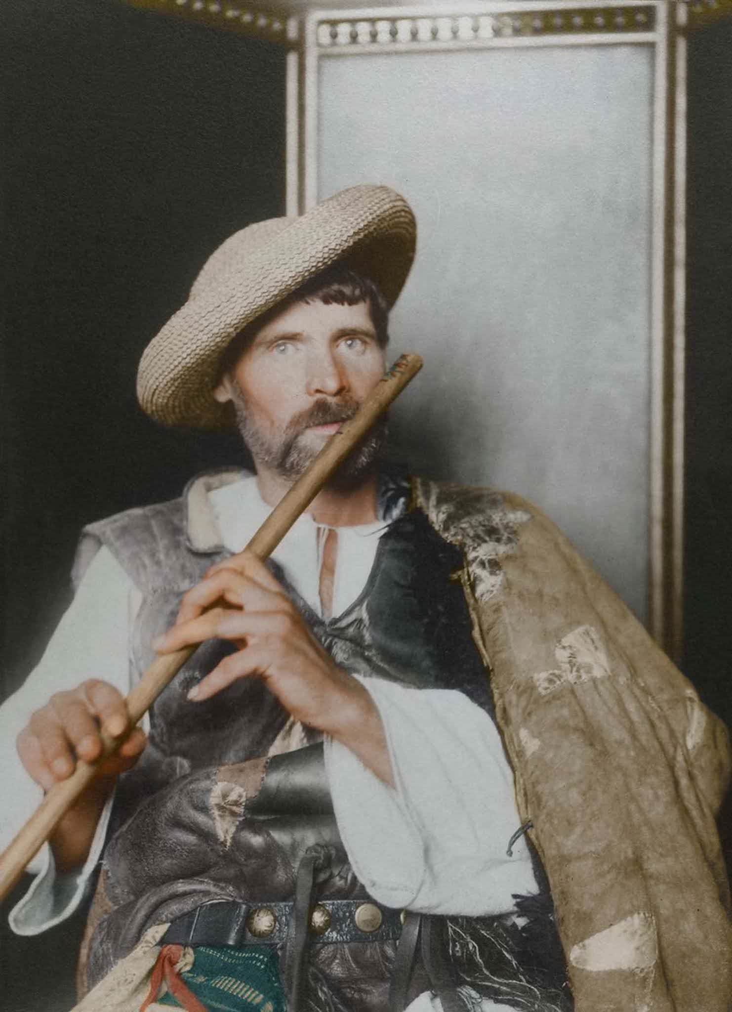 #2 Romanian piper.” This particular cojoc, an embroidered sleeved sheepskin coat, is much plainer than the shepherd’s version, making it a more practical, work-oriented coat, suggesting that the subject is of the working class given the lack of decoration and the straw hat. The waistcoat, known as a pi