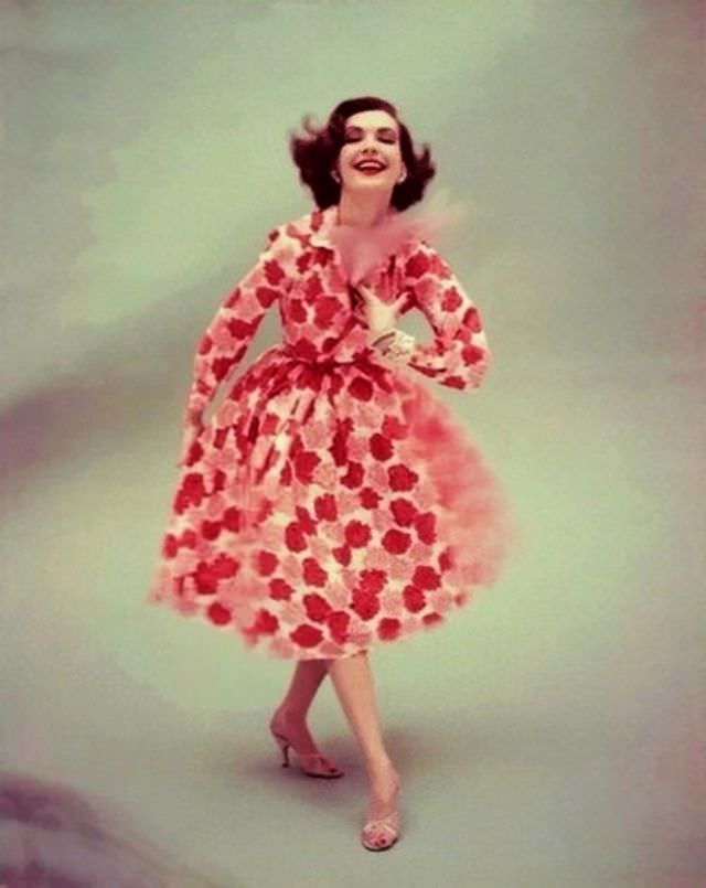#12 Model is wearing a silk shantung shirt dress, printed with a blur of red and pink carnations, 1955