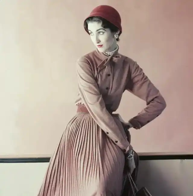 #19 Model is wearing a wool jersey blouse and a slim pleated skirt, 1952