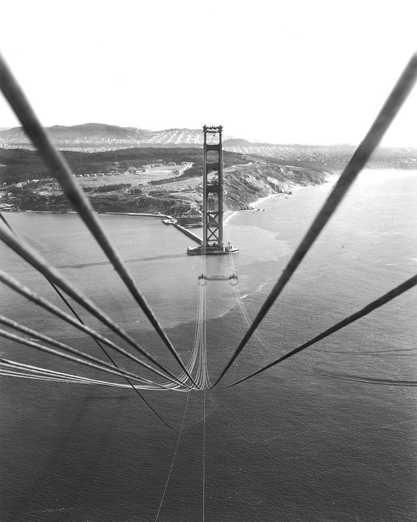 #18 Cables suspended on the Golden Gate Bridge between the towers before being bound together to support the roadbed that will hang below them.