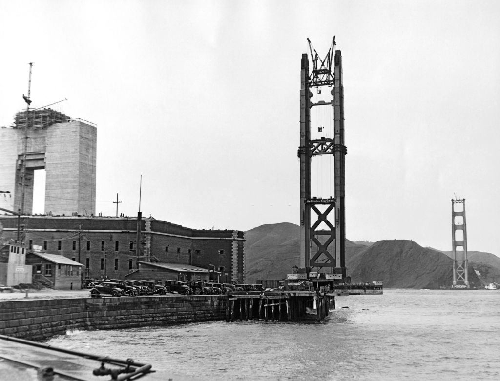 #23 The Golden Gate Bridge under construction with the Pylon #1 and the North and South Towers rising above Fort Point, 1935.
