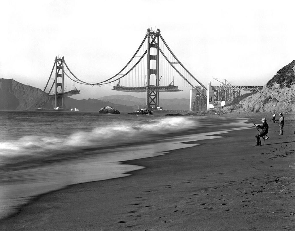 #6 Fishermen on Baker Beach enjoy the view of the Golden Gate Bridge under construction, 1936.