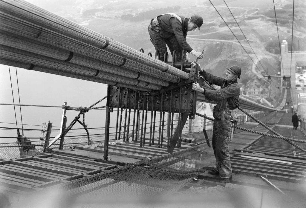 #29 Workers on the catwalks bundling the cables during the construction of the cables of the Golden Gate Bridge, 1935.