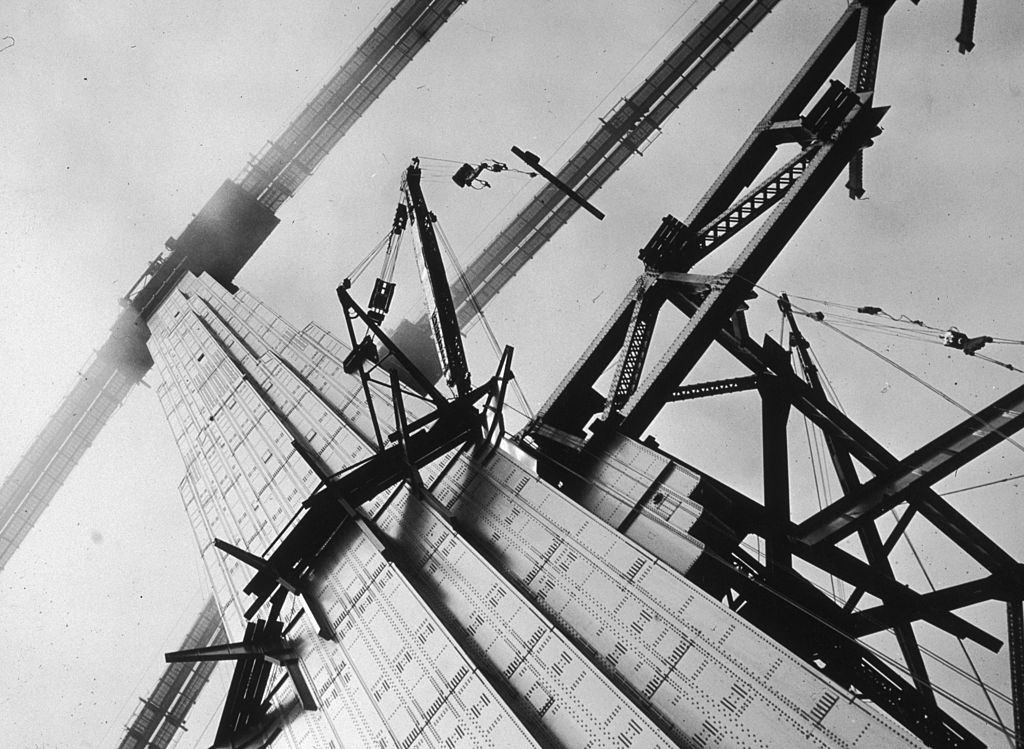#35 Construction workers attaching steel beams to the Golden Gate Bridge in San Francisco during its construction.