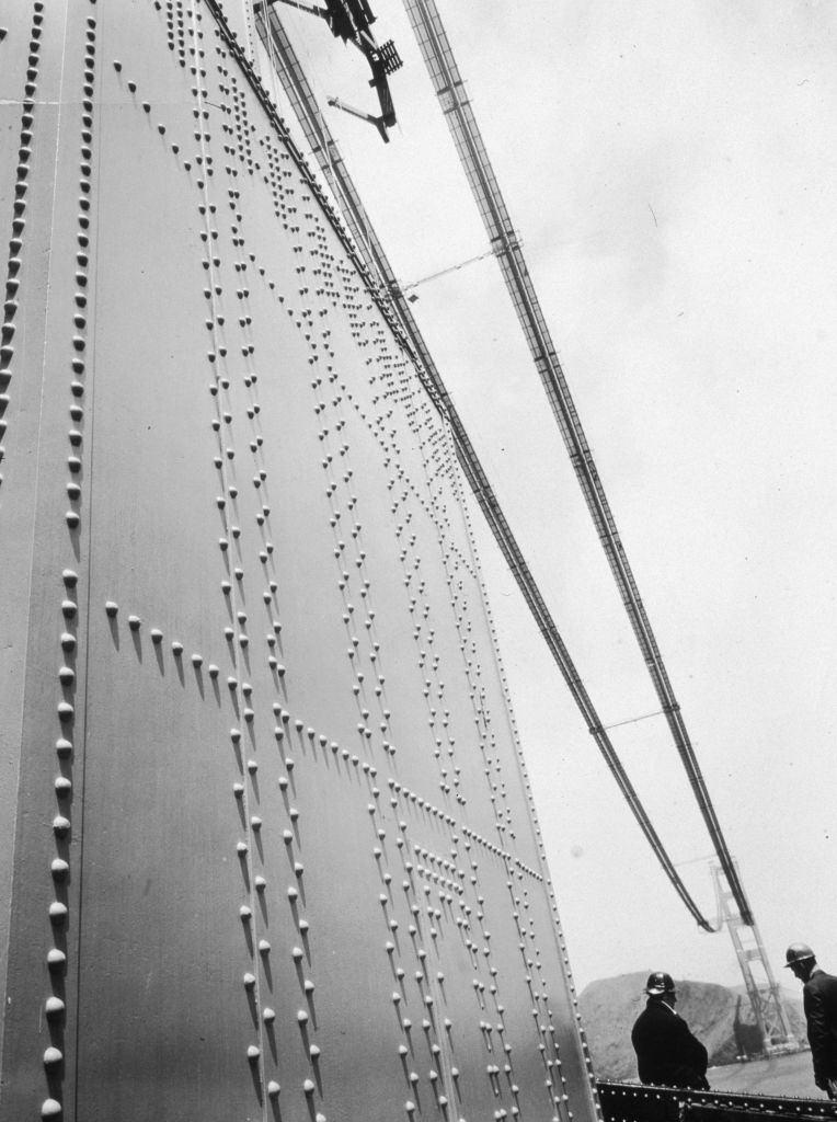 #36 Two construction workers on the Golden Gate Bridge in San Francisco during its construction.