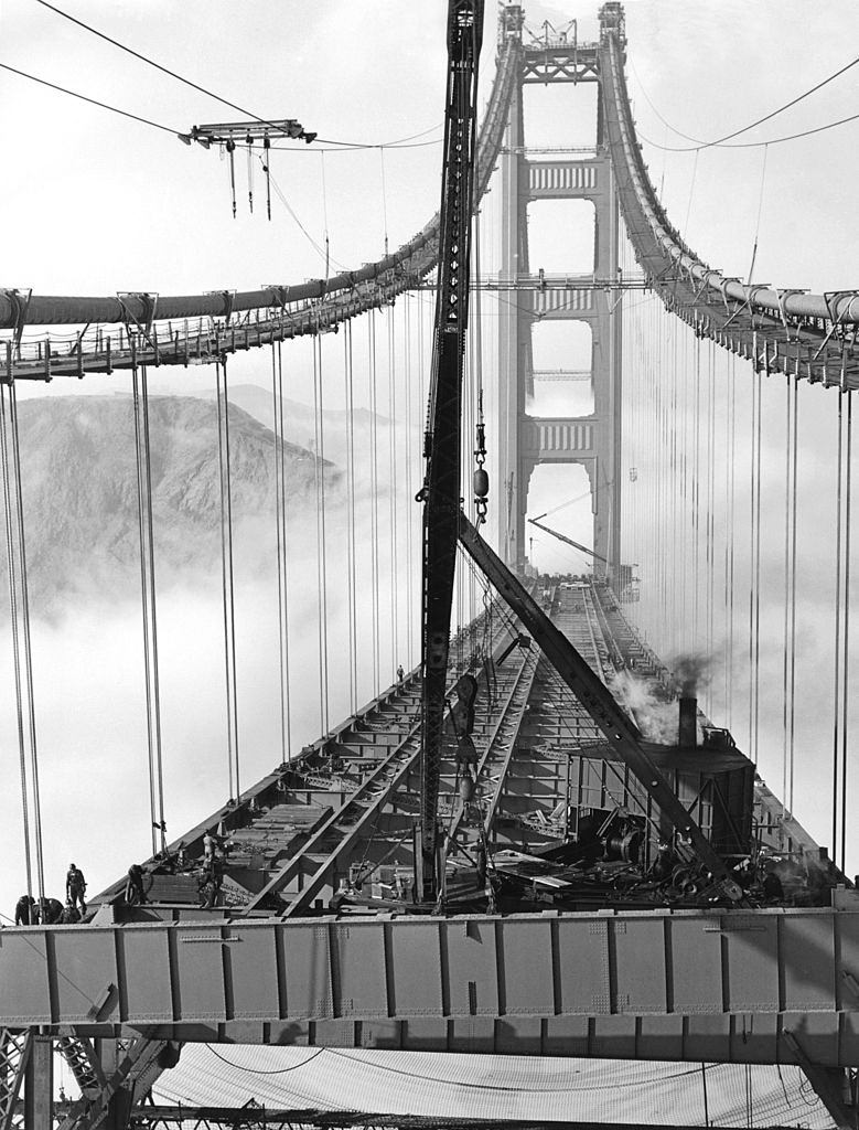 #37 Workers in the fog installing the roadbed during the construction of the Golden Gate Bridge, 1937.