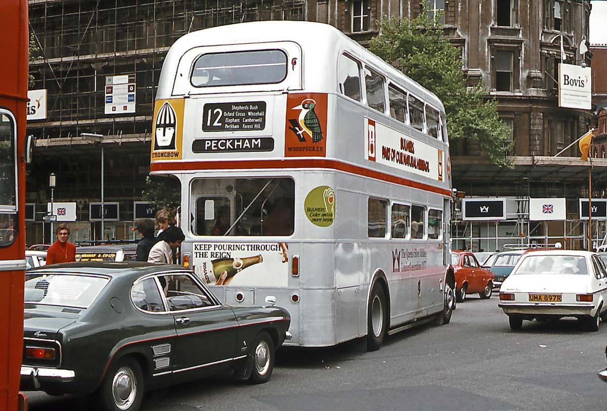 #14 Temporarily renumbered as SRM5, Bulmers Cider sponsored AEC Routemaster No. RM1668 in Queen’s Silver Jubilee livery makes it’s way through Trafalgar Square on 6th June 1977.