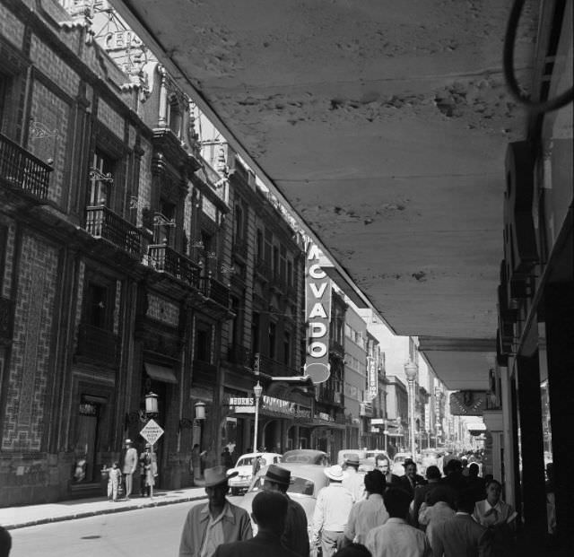 #13 Pedestrians walk down sidewalks in downtown Mexico City.