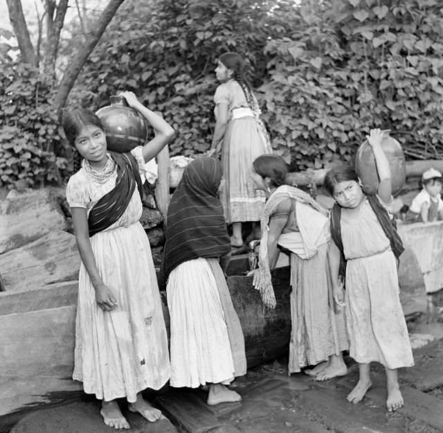 #14 Young girls get water in large jugs in Mexico City.