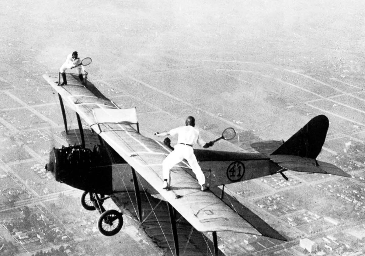 Ivan Unger and Gladys Roy play tennis on top of a biplane, 1925.