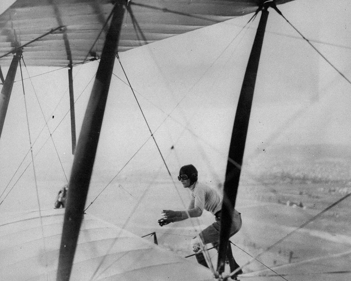 #8 Gladys Engle balances atop a biplane, 1926.