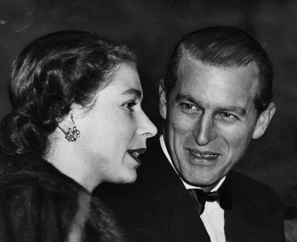 #35 The Queen and Prince Philip talk together in the royal box at a performance of Bertram Mills Circus in London, 1952.
