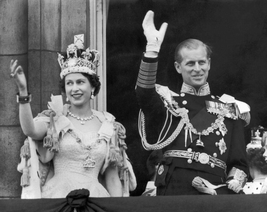 #36 The Queen and Duke of Edinburgh wave from the famous balcony of Buckingham Palace following Elizabeth’s coronation, 1953.
