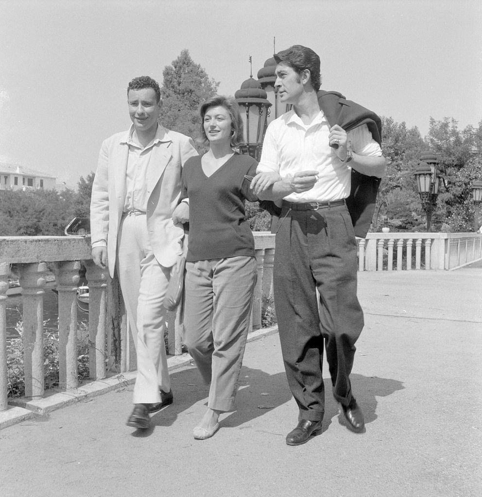 #46 Anouk Aimee with Jean Claude Pascal walking together during the XVI Venice International Film Festival. Venice, 1955