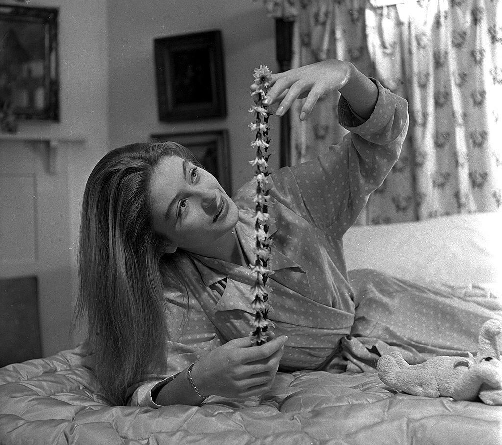 #36 Anouk Aimee with a garland of artificial flowers, 1949.