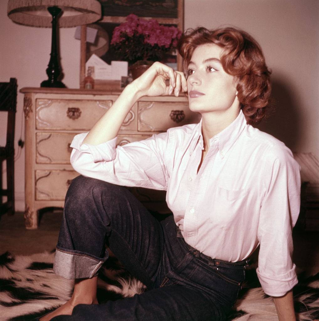 #13 A young Anouk Aimée wearing jeans and shirt in her bedroom , 1955.