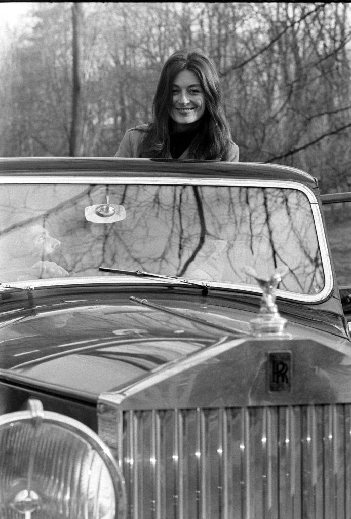#64 Anouk Aimee riding an automobile, France, 1967.