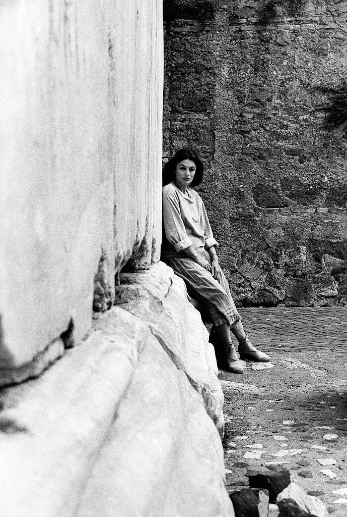 #30 Anouk Aimée, born Françoise Sorya Dreyfuss, poses against a column in the Roman ancient zone., 1975.