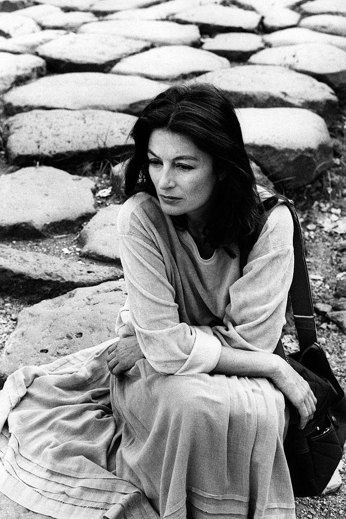 #31 Anouk Aimée sits on the ground, 1975.