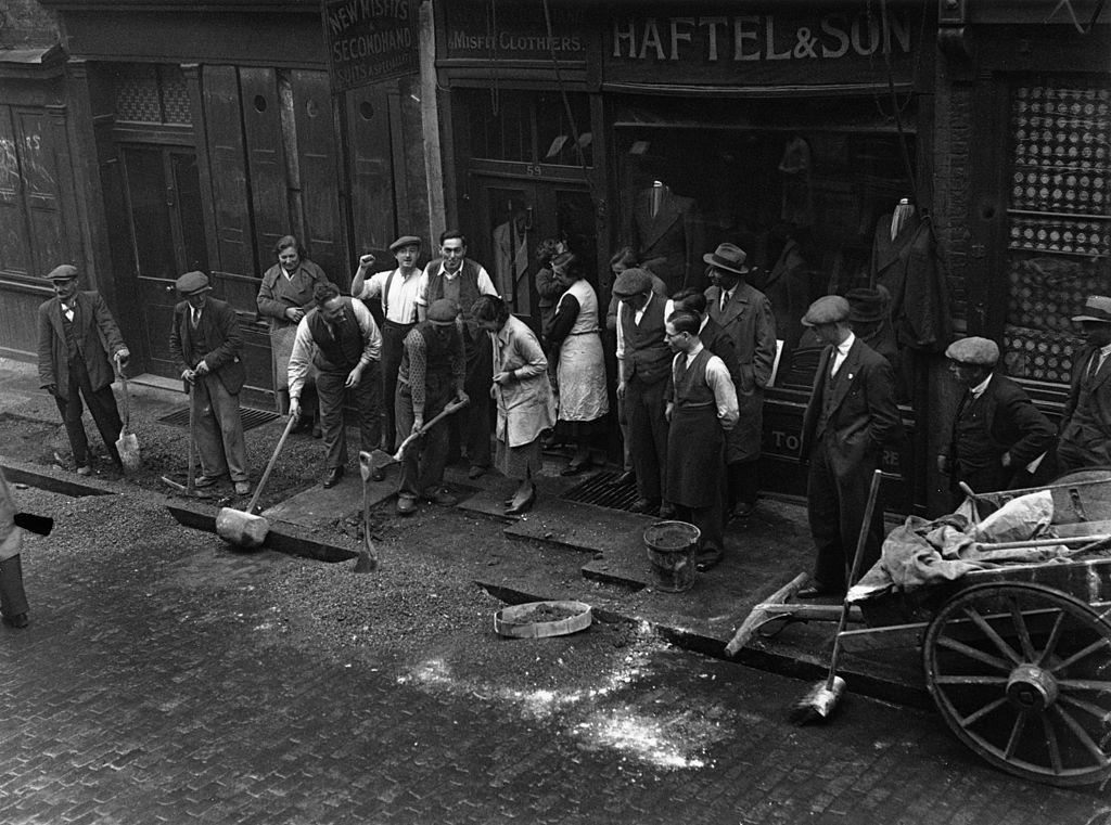 #17 Repairing a pavement in Cable Street, Mark Lane, London which was ripped up to prevent a Fascist march.