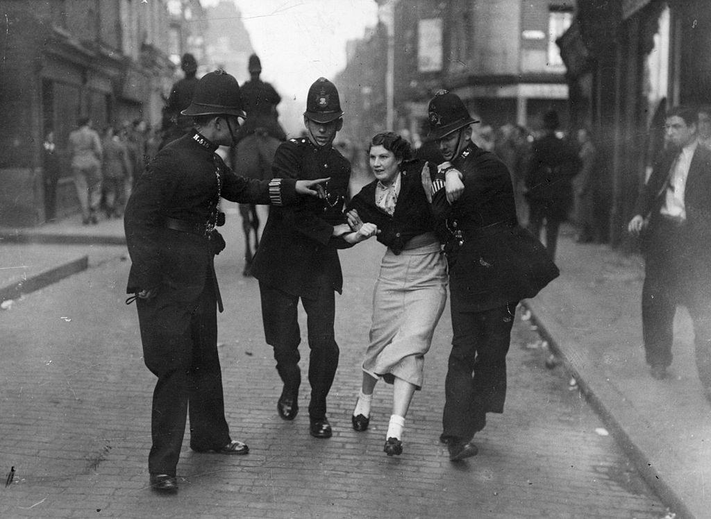 #21 Policemen arresting a demonstrator when fascists and communists clashed during a march know as the Battle of Cable Street, 1936.