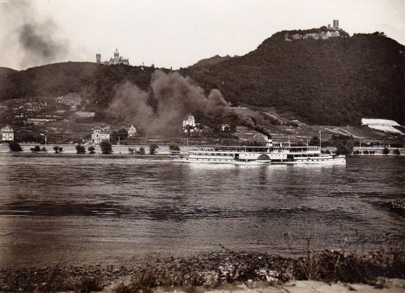 #15 An ancient paddle Steamer pushing upstream past Drachenburg Castle and Drachenfels on the River Rhine near Bonn, 1930