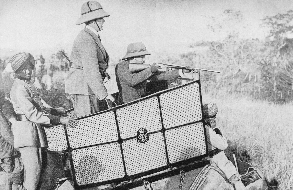 #12 The king takes aim at a tiger as his elephant driver covers his ears.