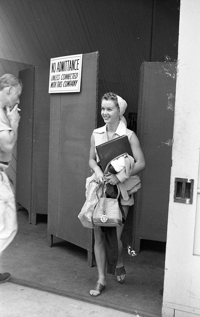 #30 Debbie Reynolds as she steps through a door on the lot of MGM studios, 1948.