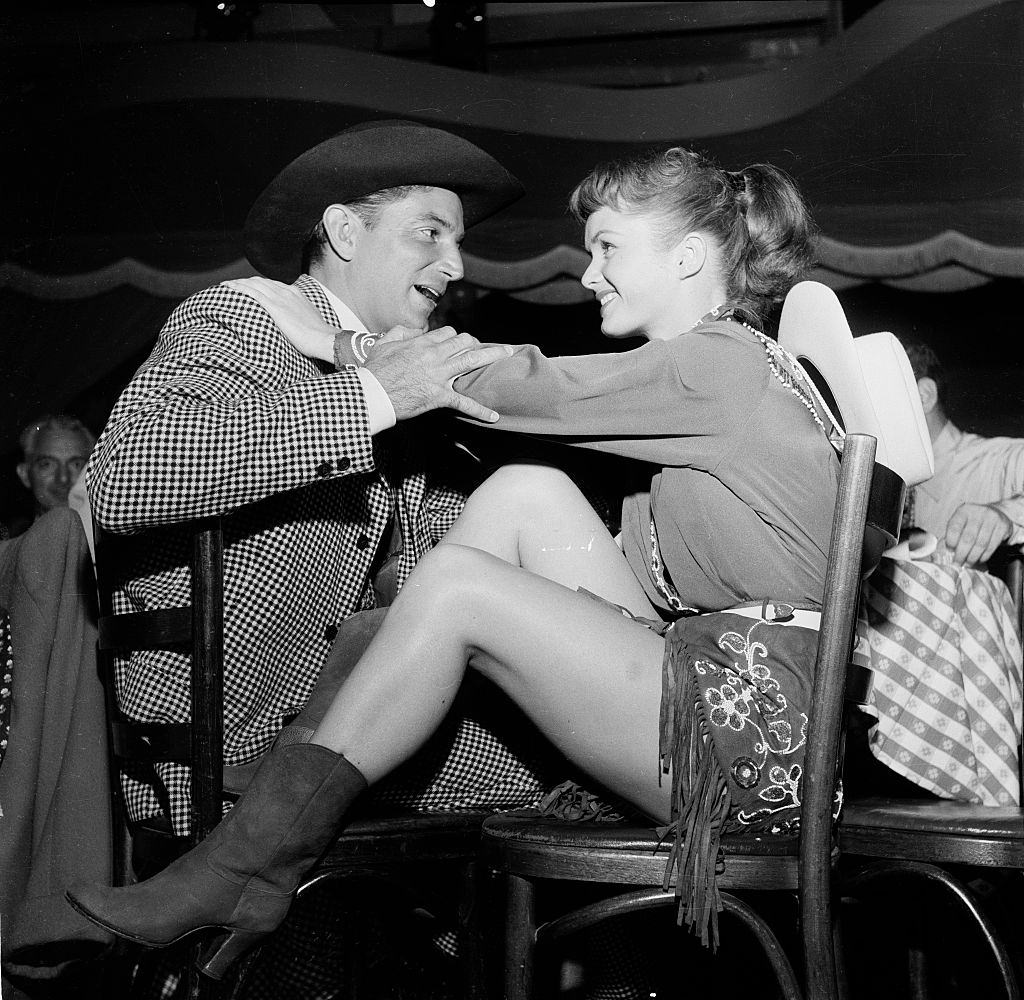 #46 Debbie Reynolds talks to a friend after her performance in Los Angeles, 1954.