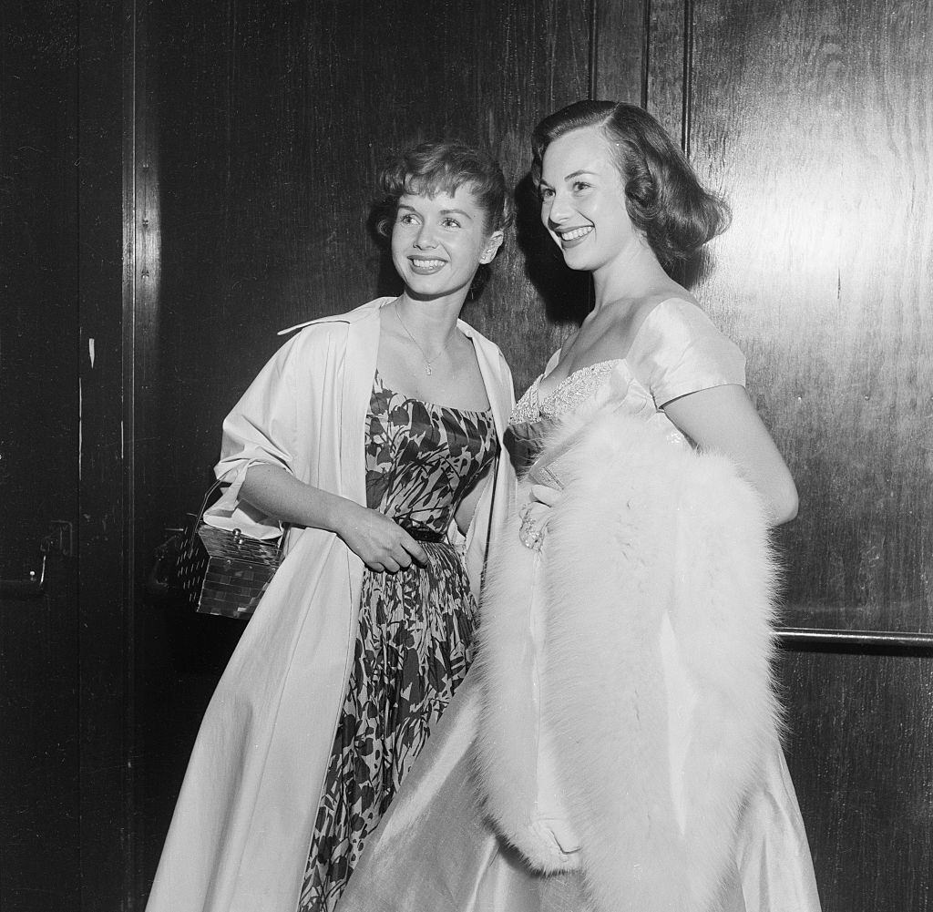 #47 Debbie Reynolds with her friend at the opening of Ice Capades, 1954.