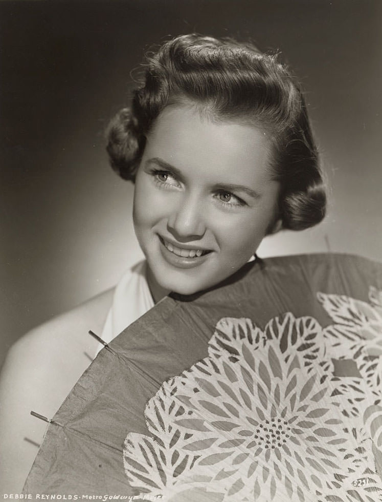 #63 Actress Debbie Reynolds holding Parasol, 1955.