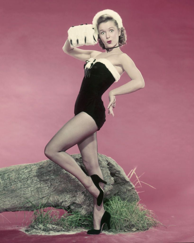 #18 Debbie Reynolds wearing a leotard and fur muff, 1955.