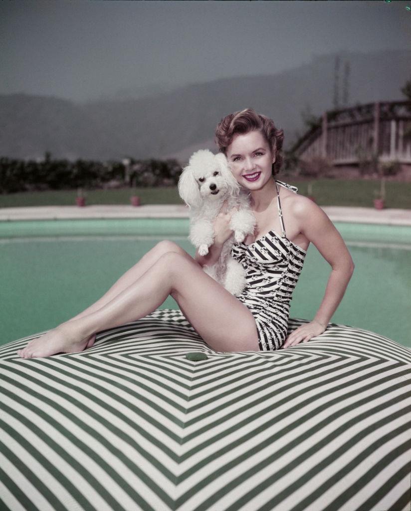 #20 Debbie Reynolds holding a dog, 1955.